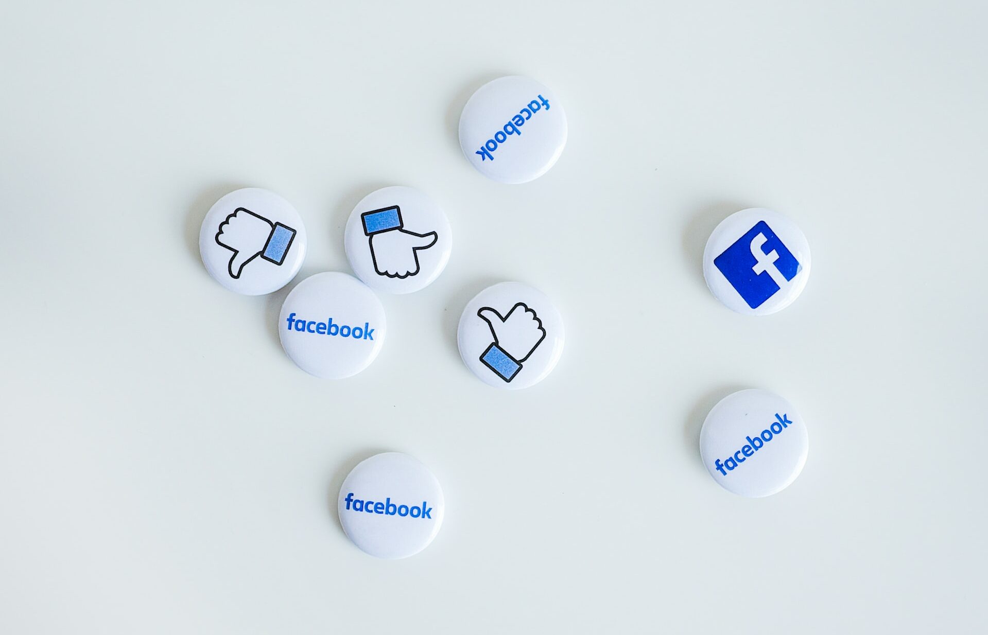 facebook marketing for dentists - pins of facebook logo and like button