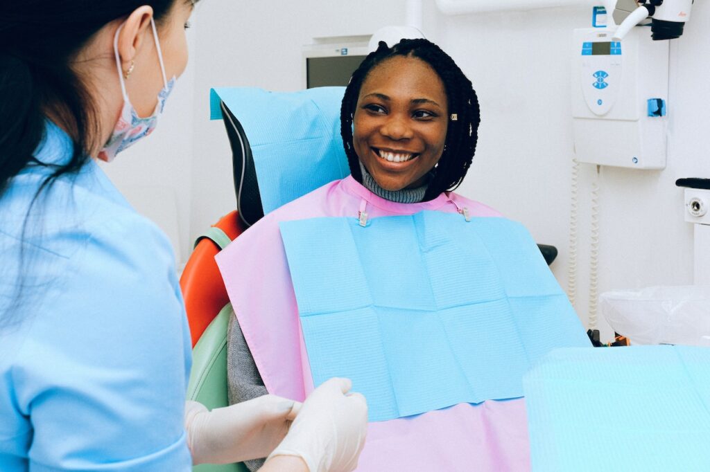 social media marketing for dentists - woman smiling in dentists chair