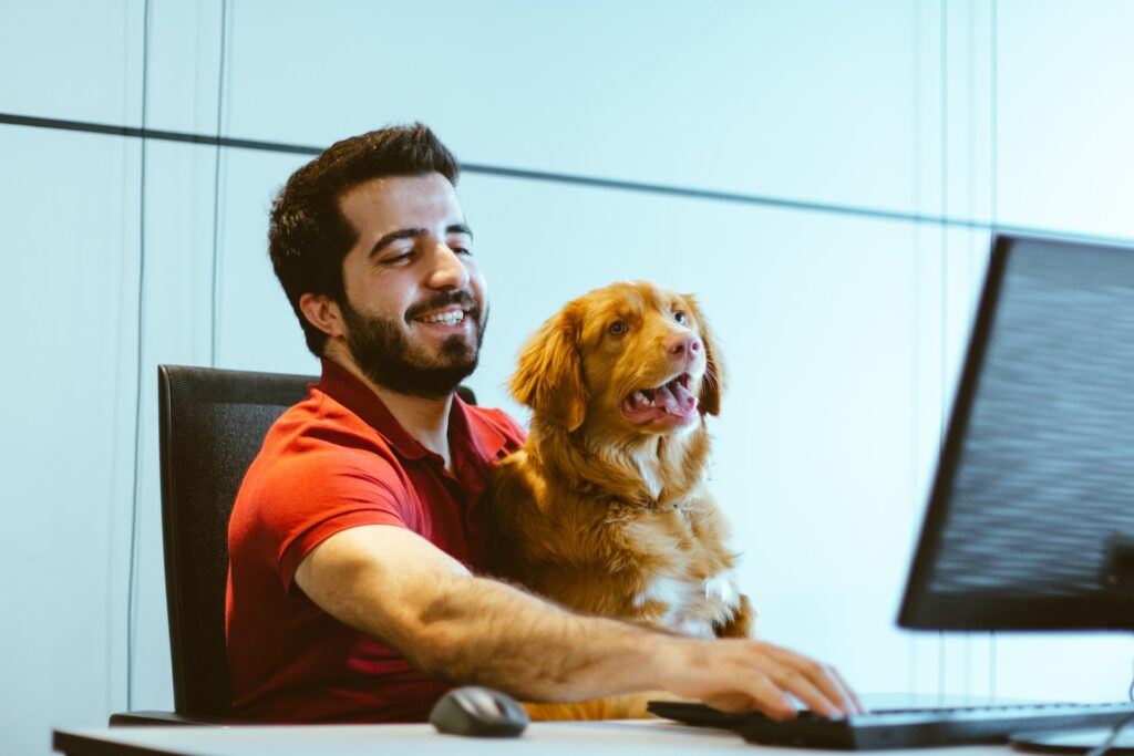 features every website should have - man using computer with dog in lap