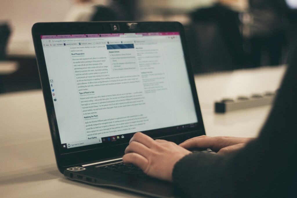 hands typing a blog on a computer