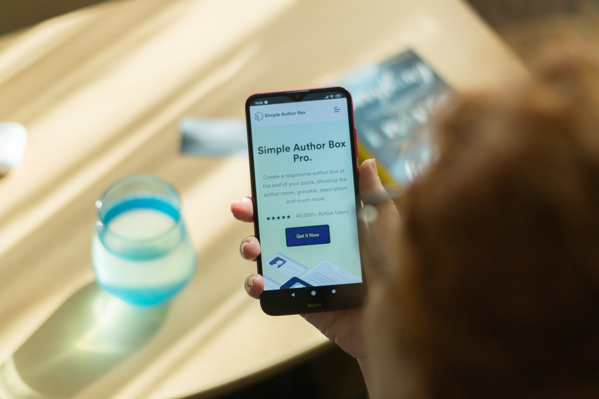A person is holding a phone with a website on the screen that is mobile optimized. One of the technical SEO tips we consider.