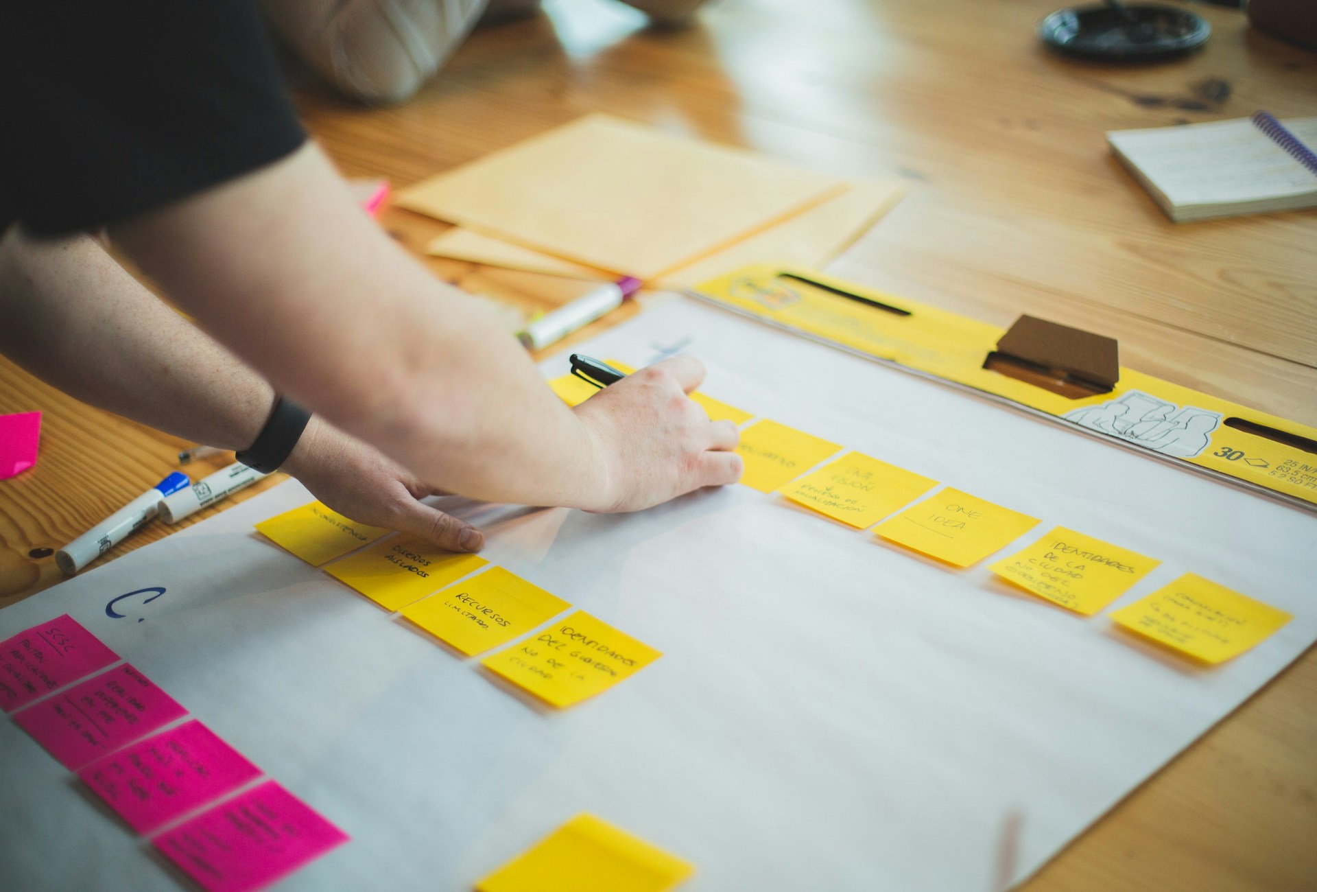 a person adding sticky notes to a marketing calendar