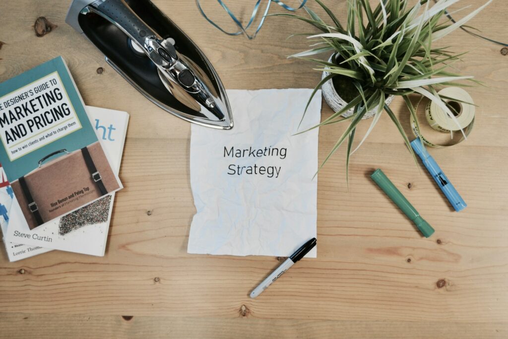 a piece of paper with the words marketing strategy is laid on a table