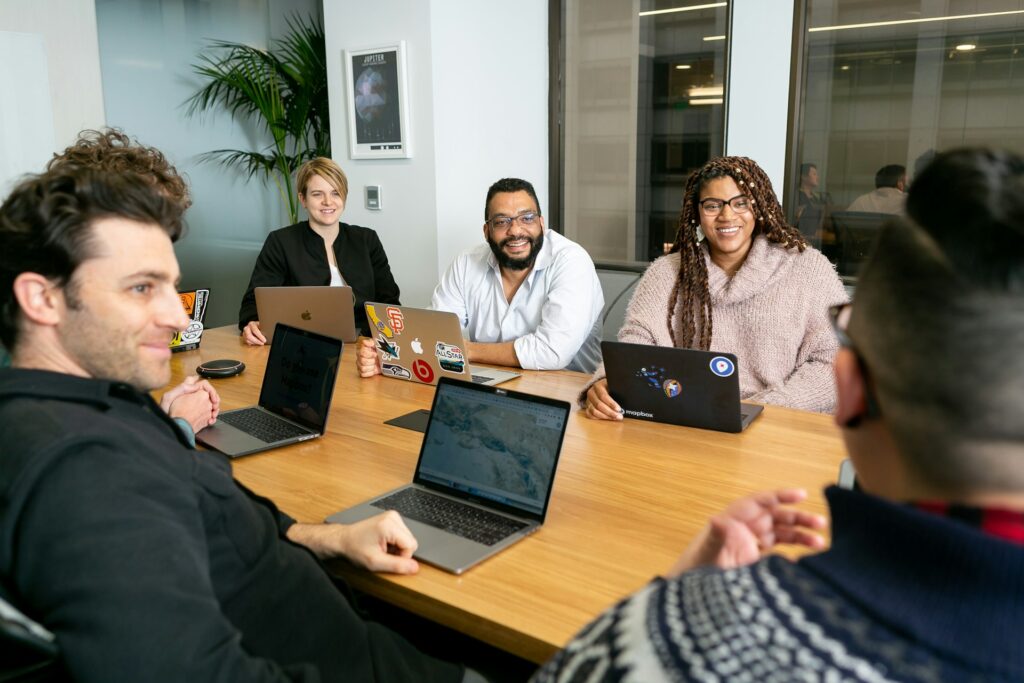a group of marketers are sitting around a table discussing marketing infrastructure